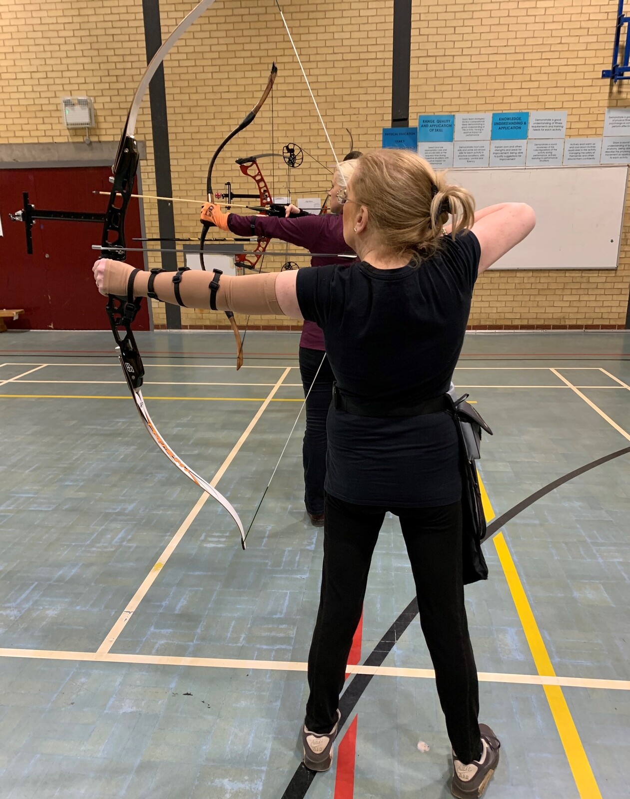Female disabled archer shooting on indoor range